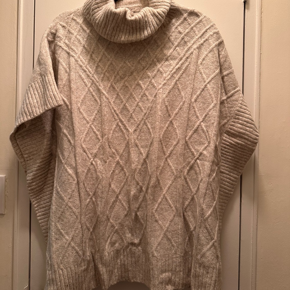 Poncho-style cable knit sweater